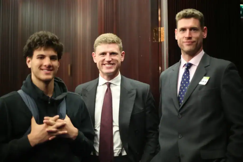 Team members at a professional event in formal attire.