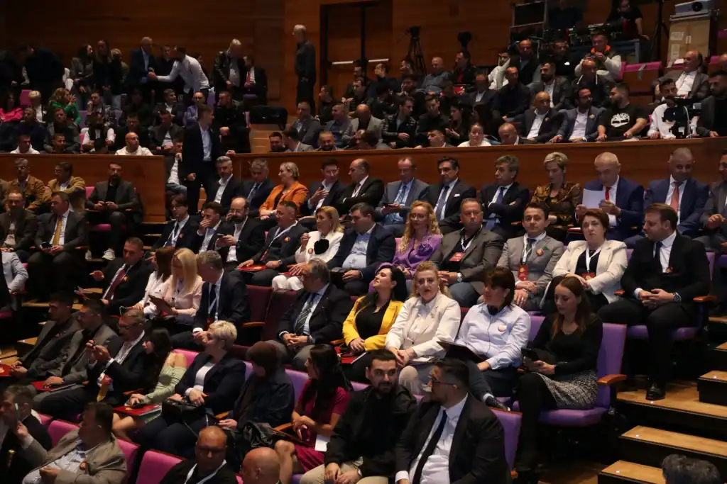 Diverse audience seated in a conference hall during an event.