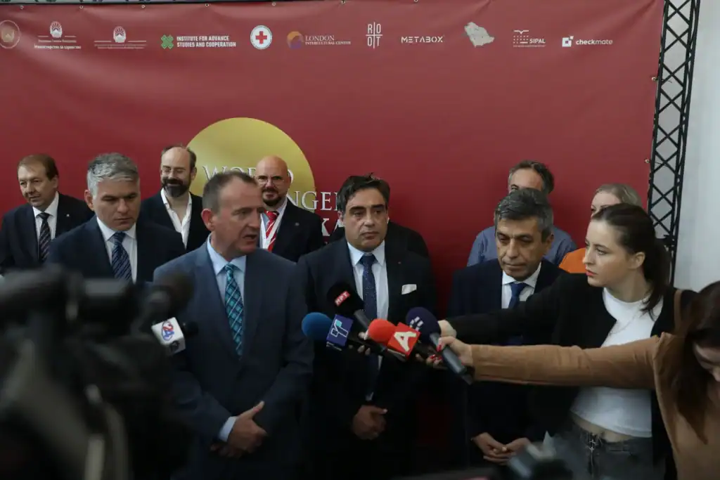 Group of officials speaking at a press event with microphones and media.